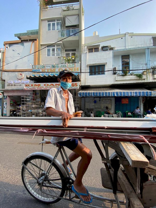 Hoa hậu Võ Thu Sương cúi xuống thật gần với người bán vé số, ve chai